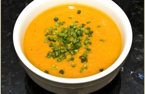 A bowl of squash soup with spring onions